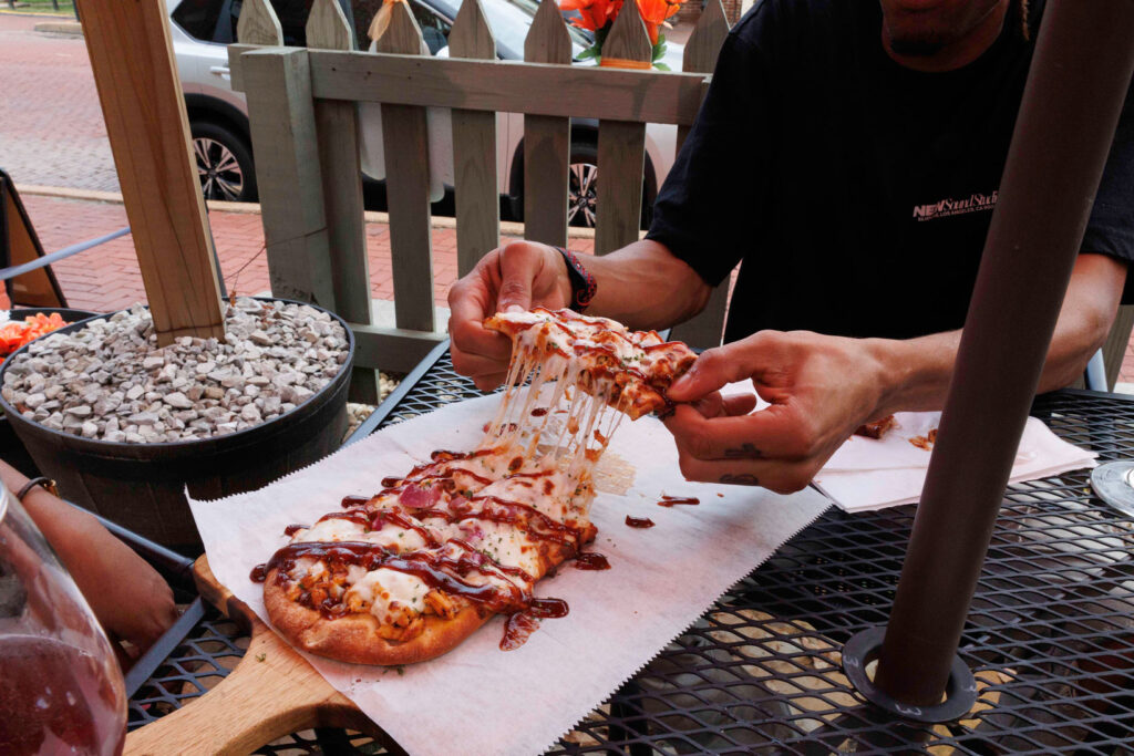 A young couple enjoying gourmet pizza on Historic Main Street in St. Charles, MO.